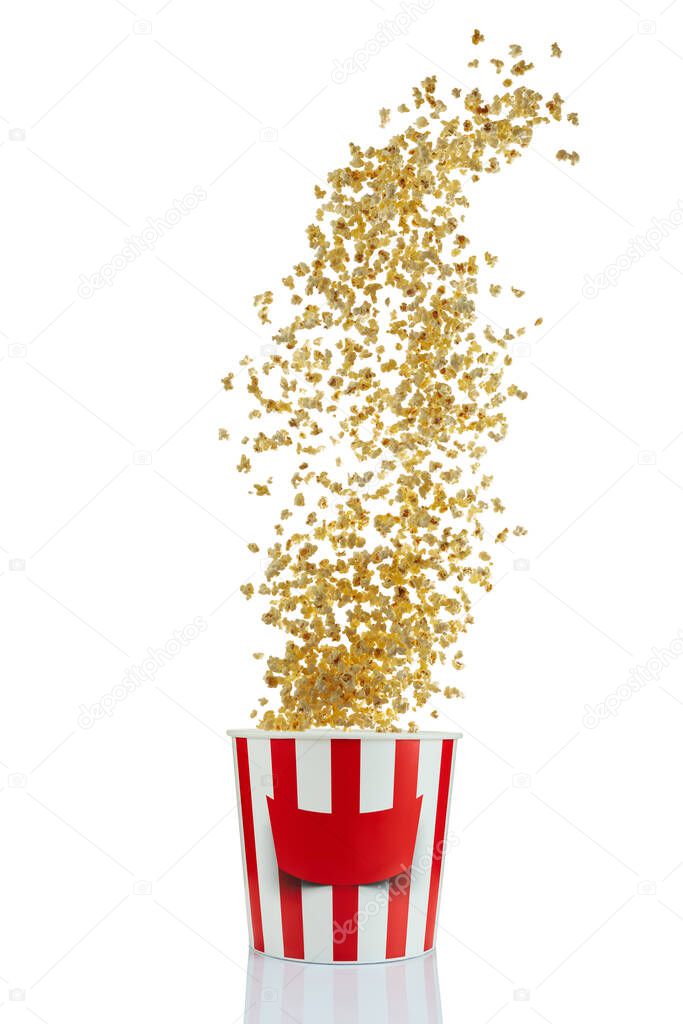 Flying popcorn from red and white paper striped bucket