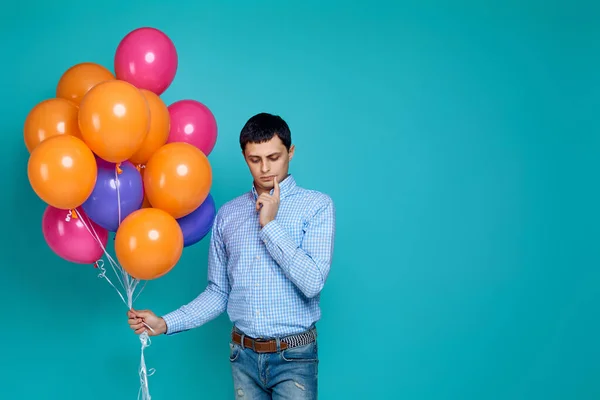 caucasian man in shirt with bright colorful balloons
