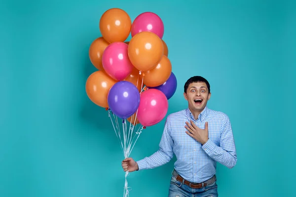 Muž v košili drží světlé barevné balónky — Stock fotografie