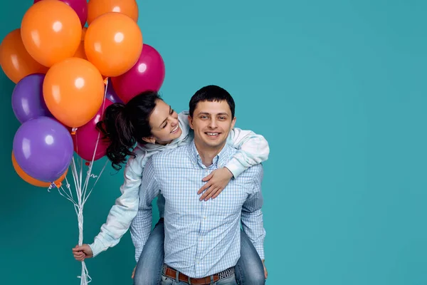 Chica feliz está sentado en la parte posterior de su novio, que están bailando y divirtiéndose . — Foto de Stock