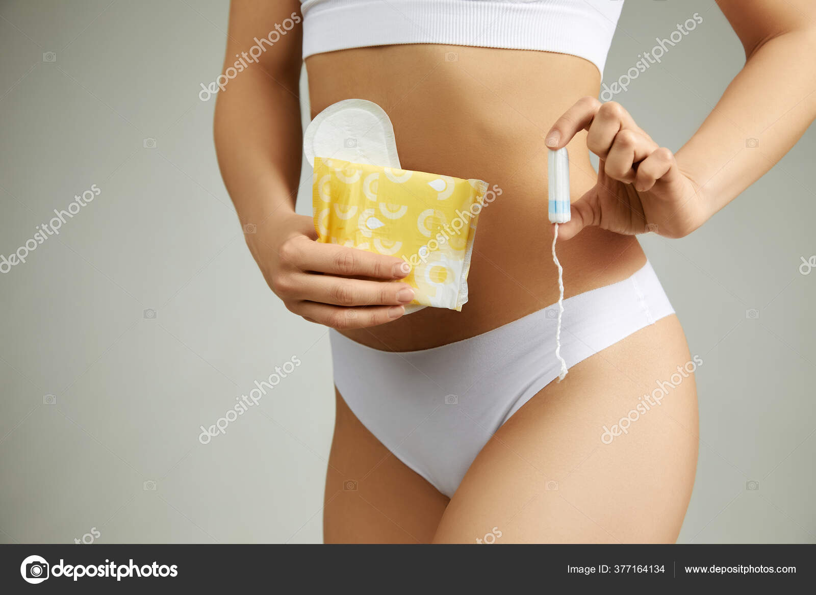 Woman with sanitary pad and cotton tampon Stock Photo by ©erstudio