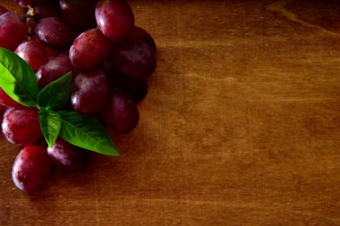 Tahta bir masada organik siyah üzümler.