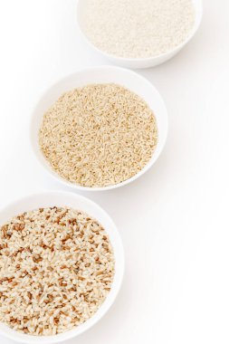 Farklı türde pişmemiş pirinç içeren kaseler: kahverengi, kırmızı, beyaz, glutinous. Asya 'nın en popüler sağlıklı yiyeceği.