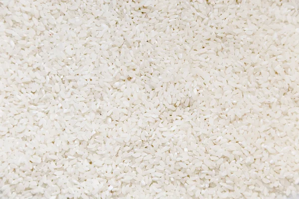 Heap of white glutinous rice close-up as background. Organic white rice, glutinous rice or sticky rice for design nature foods background.