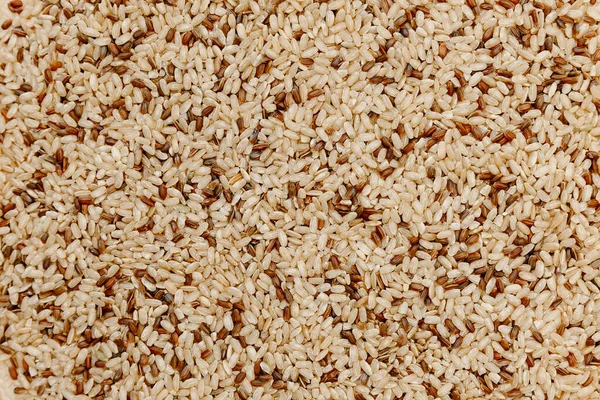 A mixture of brown and red rice. Rice cereal texture. Background and texture. Healthy Food, Asian