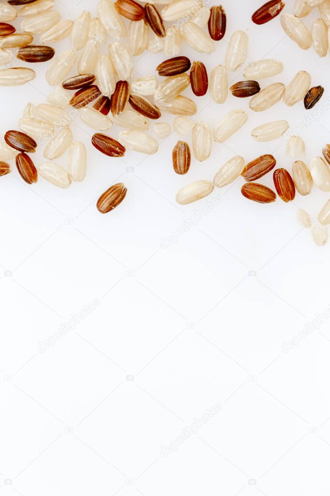 A mixture of brown and red rice on a white background. Rice cereal texture. Healthy Food, Asian