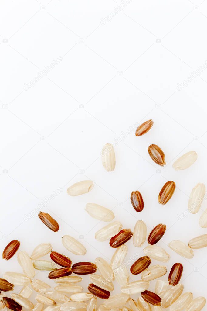 A mixture of brown and red rice on a white background. Rice cereal texture. Healthy Food, Asian