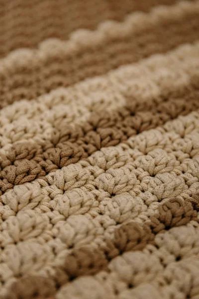 Knitted brown rug texture. Antique handmade carpet. Home hobby. Background