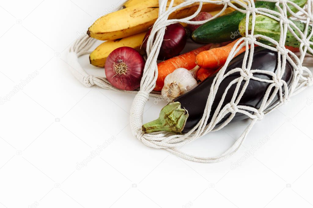 Shopping bag with vegetables and fruits on white background, isolated, top view with copy space