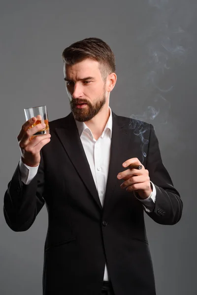 Rich man with drink and tobacco — Stock Photo, Image
