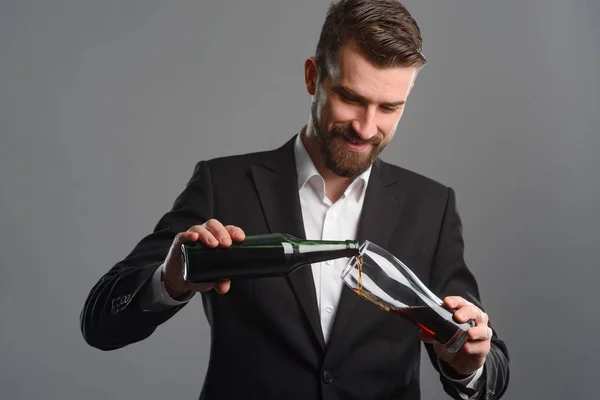 Man filling glass with beer