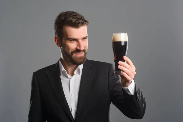 Man staring at beer glass