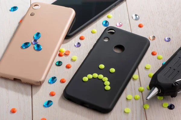Phone cases with rhinestone flower and bead sad smile — Stock Photo, Image