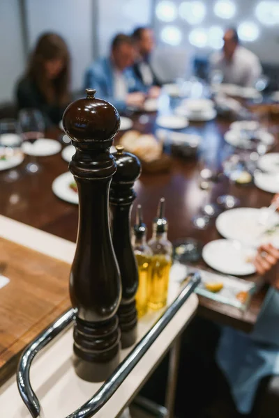 Pepper mills and bottles of olive oil — Stock Fotó