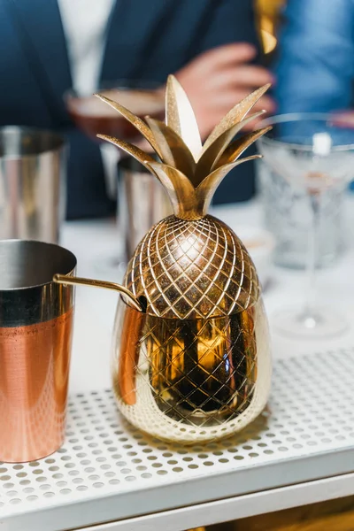 Copper pineapple tumbler cup on a desk at a restaurant