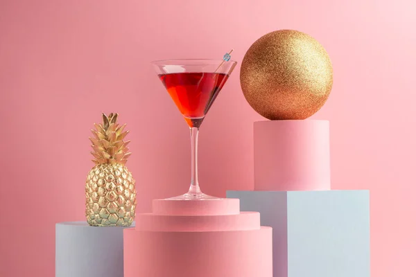Glass of Manhattan cocktail, golden pineapple and glitter ball — Stock Photo, Image