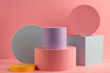 Pembe arkaplanda renkli kağıt silindirler ve küp