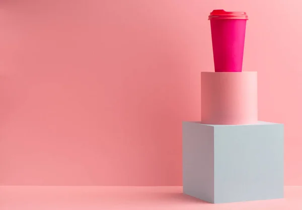 Taza de papel café brillante sobre fondo rosa con espacio para copiar —  Fotos de Stock