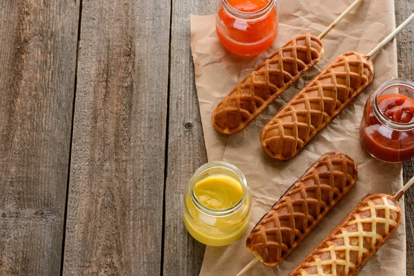 Corn dogs, mustard, ketchup and barbecue sauce