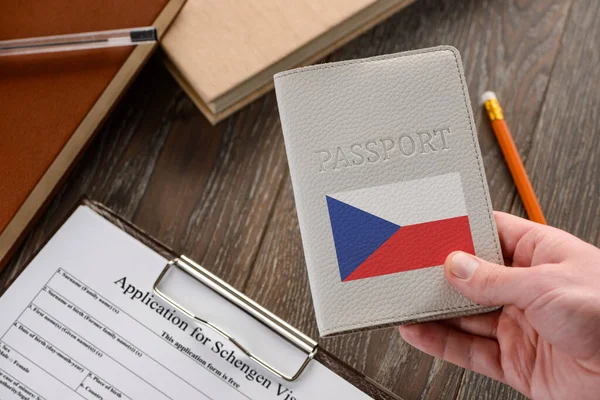 Çek pasaportu, arka planda bir başvuru formu.