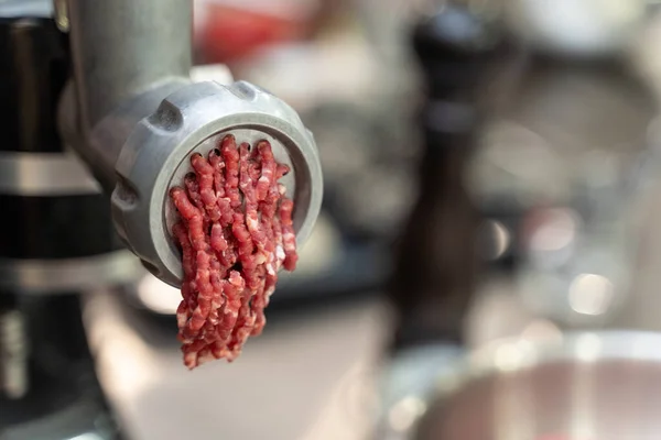 Close-up on minced meat out of an electric grinder — Stok Foto