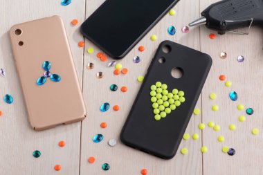 Cep telefonu kılıfları sahte elmaslar ve boncuklarla süsleniyor.