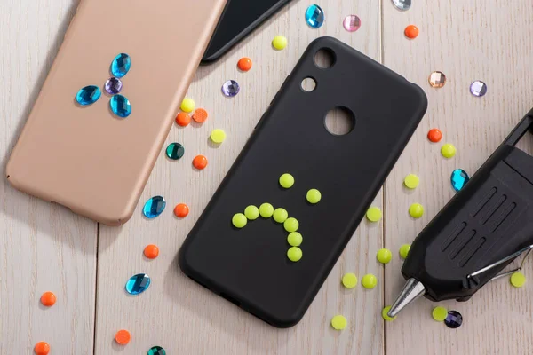 Phone cases styled up with rhinestone and bead art — Stock Photo, Image