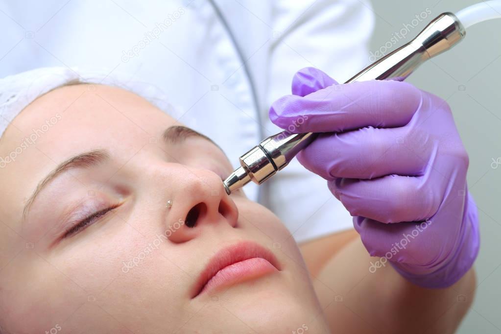 Diamond microdermabrasion, peeling cosmetic. woman during a micr