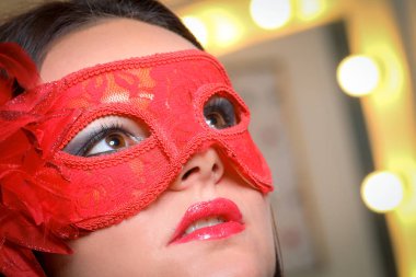 Beauty model woman wearing masquerade carnival mask over Christm clipart
