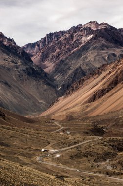 And Dağları 'nın ardında bir kış günü ve bulutlu bir gökyüzünde güzel bir dağ yolu manzarası.