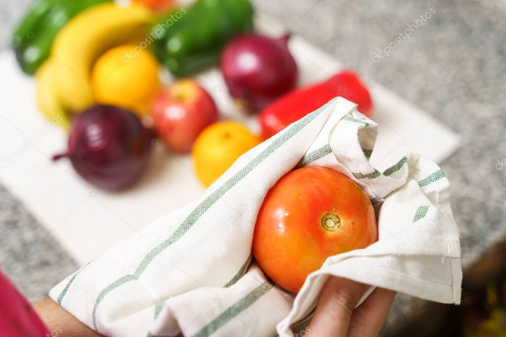 Cleaning the fruits and vegetables with a towel for the coronavirus.