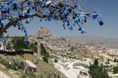 Uchisar Castle and Evil Eye Beads Tree in Cappadocia clipart