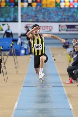 ISTANBUL, TURKEY - FEBRUARY 02, 2020: Undefined athlete triple jumping during Turkish Indoor Athletics Championships