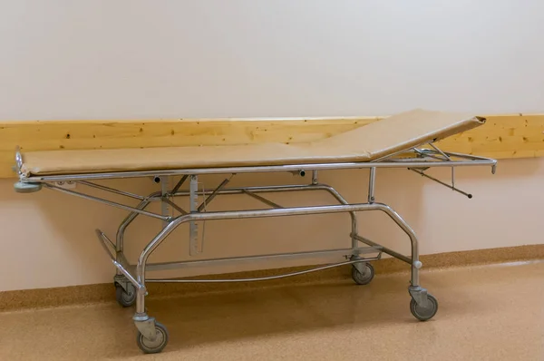 Gurney bed or wheeled stretcher for transporting bedridden patients in the hospital corridor