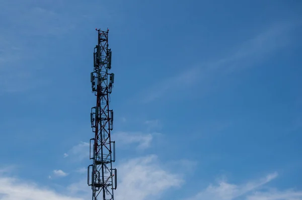 Cellular communication tower - a system complex of transceiver equipment that provides centralized service to a group of subscribers. Photo of a cellular tower against a blue sky. Copy space.