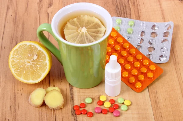 Pills, nose drops and hot tea with lemon for colds, treatment of flu and runny