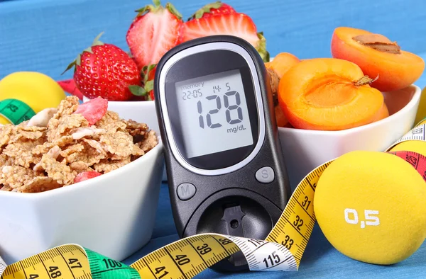 Glucometer with sugar level, healthy food, dumbbells and centimeter, diabetes, healthy and sporty lifestyle