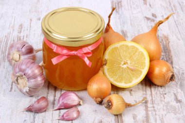 Honey in glass jar, onion, lemon and garlic, healthy nutrition and strengthening immunity