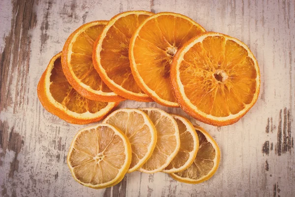 Vintage photo, Slices of dried lemon and orange on old wooden background — Stock Photo, Image