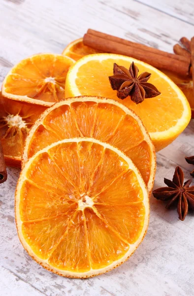 Dried and fresh orange with spices on old wooden background — Stock Photo, Image