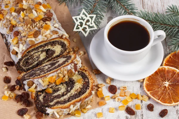 Poppy seeds cake, cup of coffee and spruce branches, dessert for Christmas