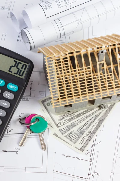 House under construction, keys, calculator, currencies dollar and electrical drawings, concept of building home