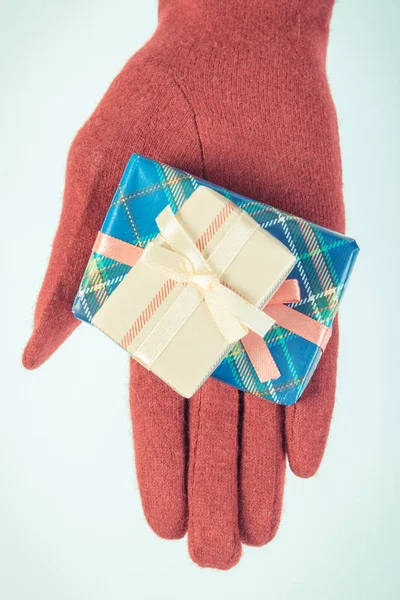 Vintage φωτογραφία, το χέρι της γυναίκας στα γάντια με δώρα για τα Χριστούγεννα ή άλλη γιορτή — Φωτογραφία Αρχείου