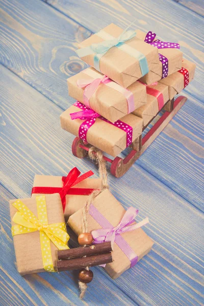 Foto vintage, trineo de madera y regalos envueltos con cintas para Navidad u otra celebración —  Fotos de Stock