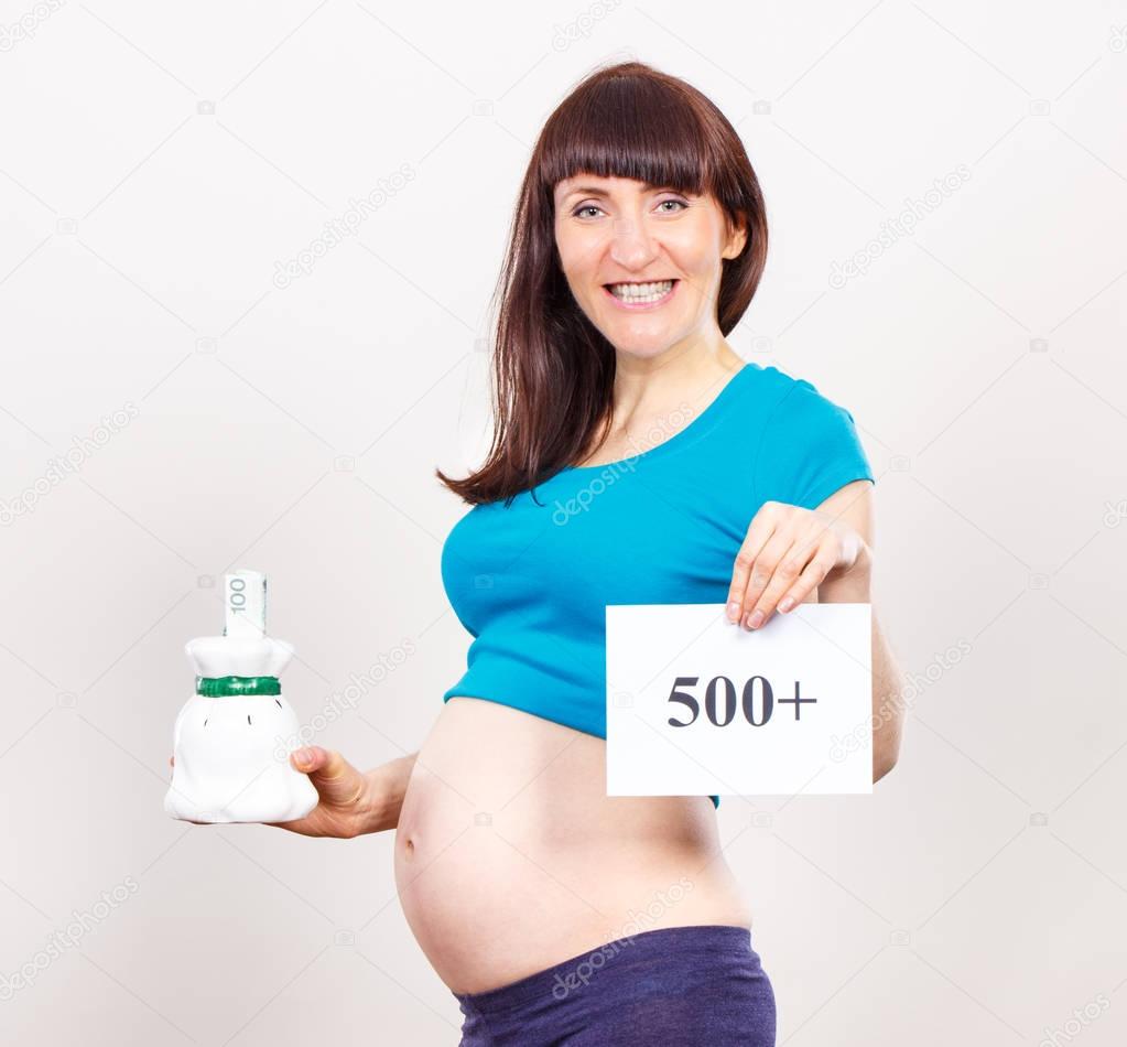 Pregnant woman holding piggy bank and inscription 500+, social program and policy in Poland