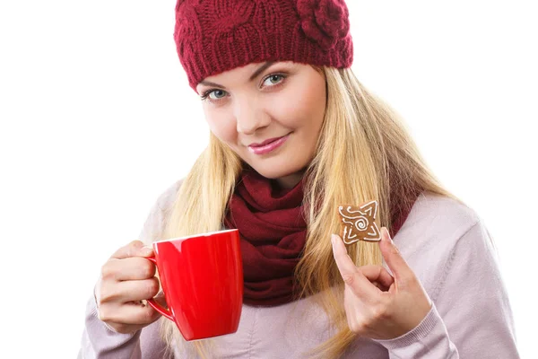 Donna in berretto e scialle in possesso di pan di zenzero e tazza di tè caldo, periodo natalizio — Foto Stock