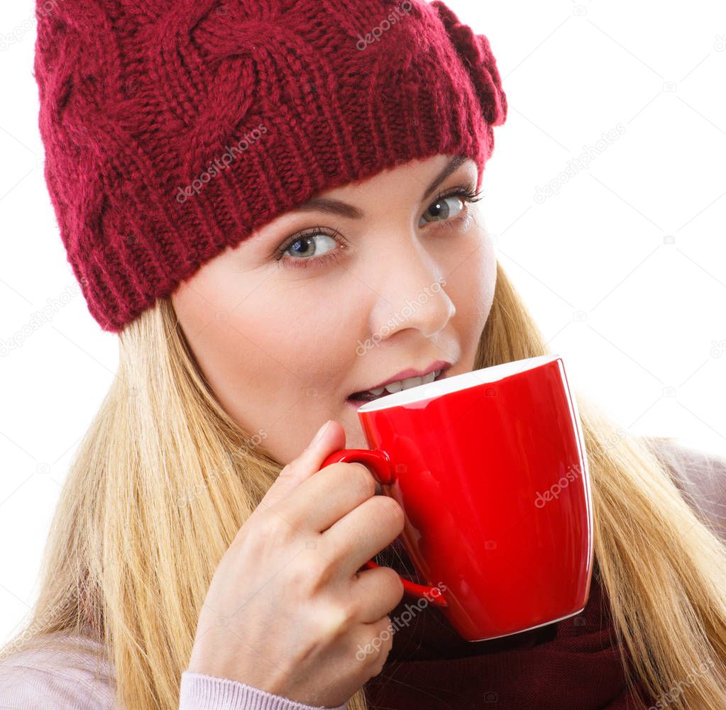 Woman in cap and shawl drinking tea or coffee, christmas time