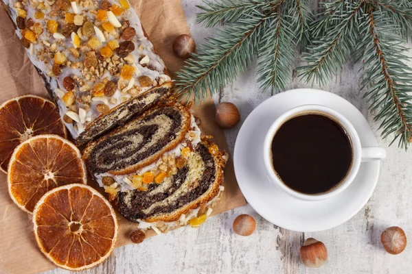 Poppy seeds cake, cup of coffee and spruce branches, dessert for Christmas