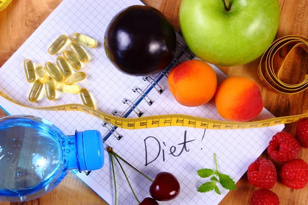 Fruits, tablets supplements and centimeter with notebook, slimming and healthy food — Stock Photo, Image