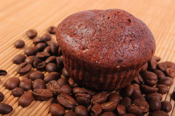 Fresh baked chocolate muffins and coffee grains — Stock Photo, Image